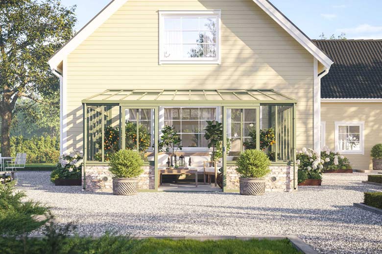Växthuset “Lean to Elegant” i aluminium från Willab Garden byggs snyggt mot en husvägg.
